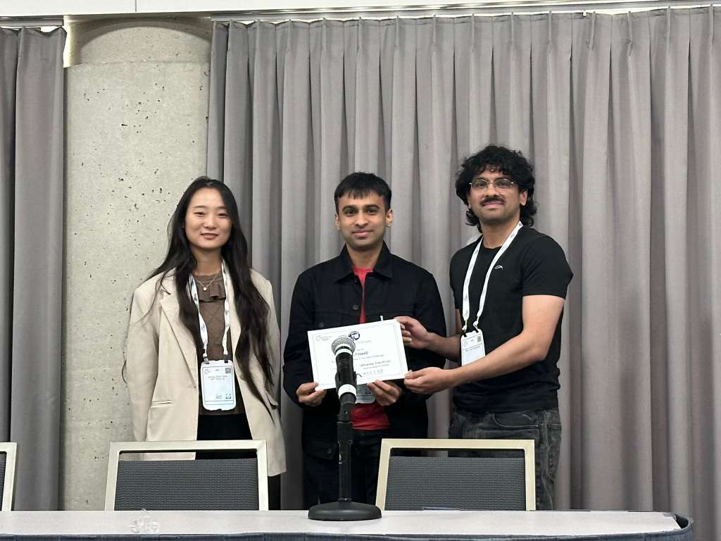 San and his brother receiving their research award